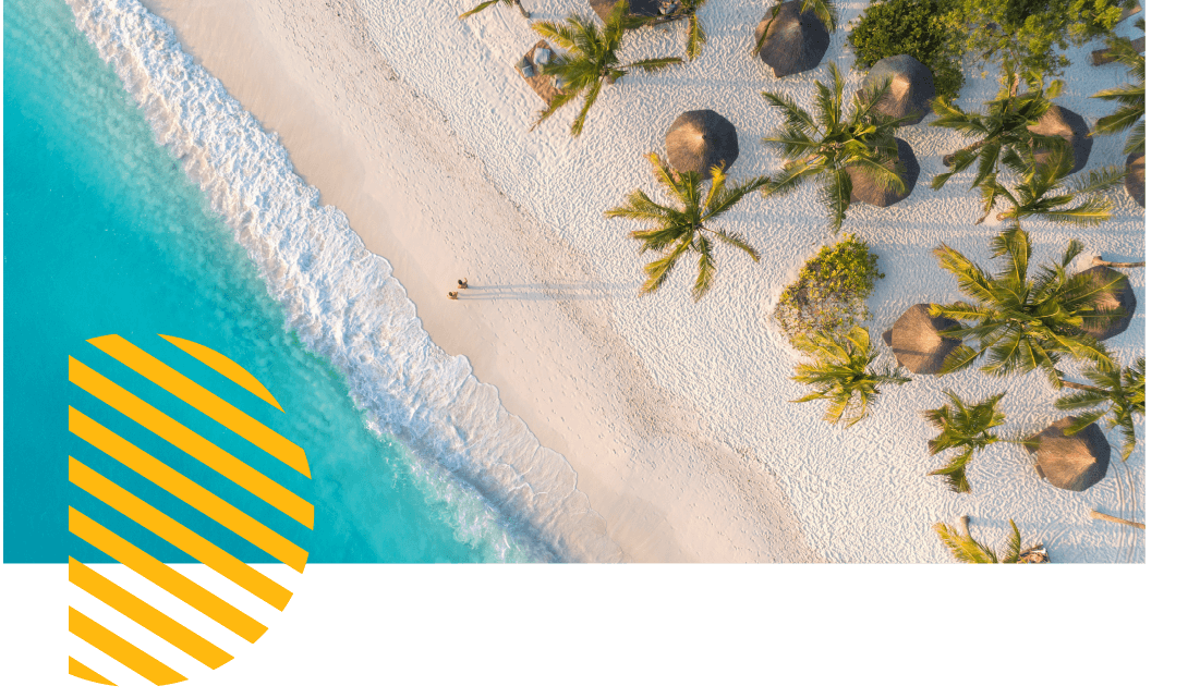 Aerial view of a beach with white sand, palm trees and parasols. 