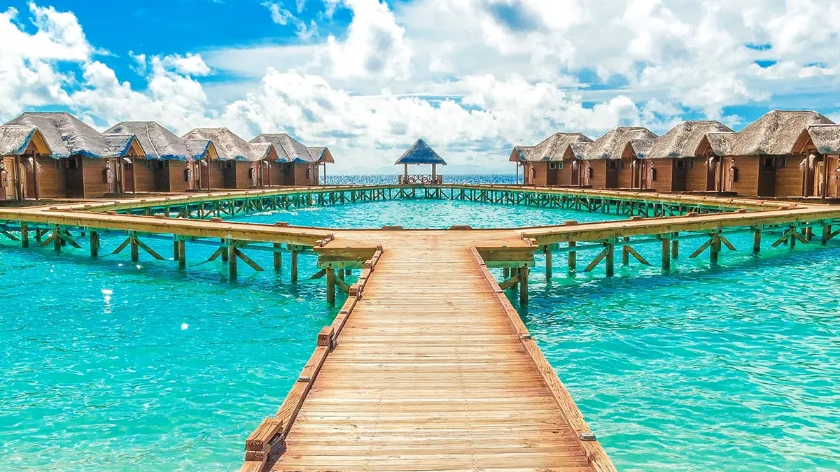View of wooden bungalows on the ocean in the Maldive Islands.