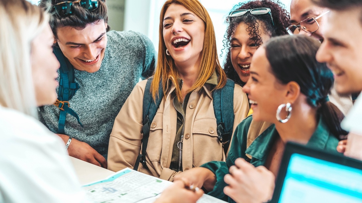 Group of people laughing and smiling at a hotel reception.