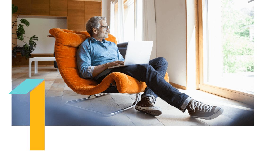 Man in an orange chair with a laptop in his lap, looking out of a window. Man in an orange chair with a laptop in his lap, looking out of a window.
