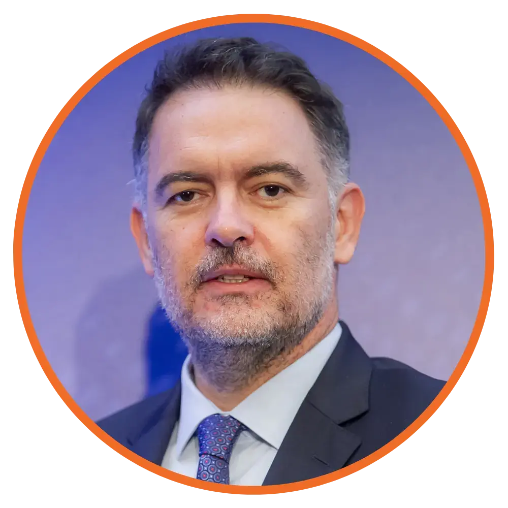 A headshot of Alexandros Vasilikos, President, Hellenic Chamber of Hotels, in a circle frame.