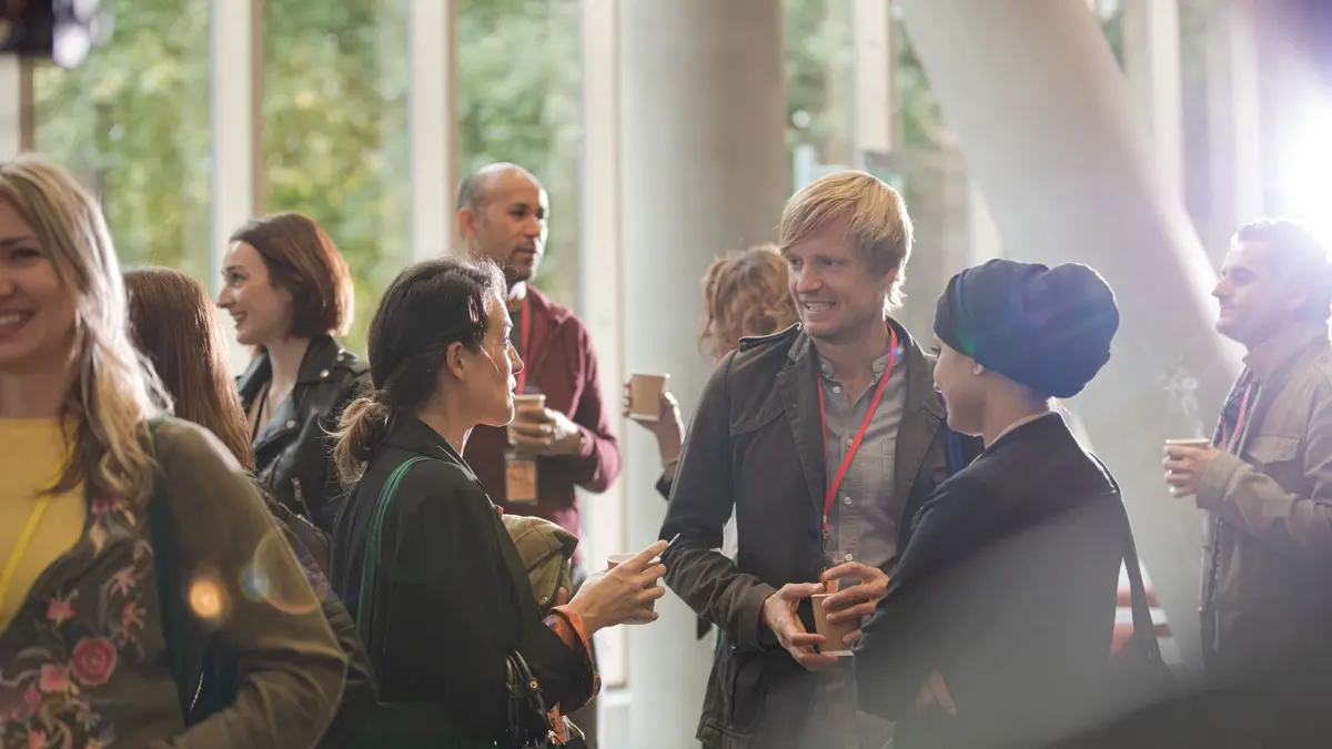 A group of people chatting at an event.